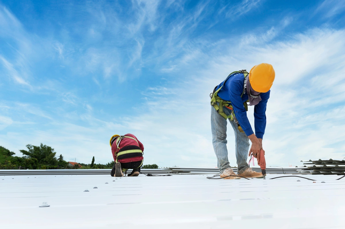 professional workers repairing the commercial roof