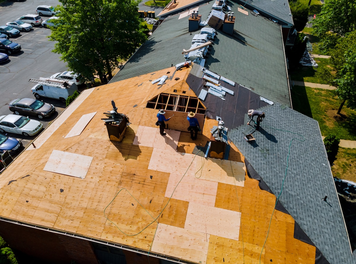 Construction worker on a renovation roof the house installed new shingles